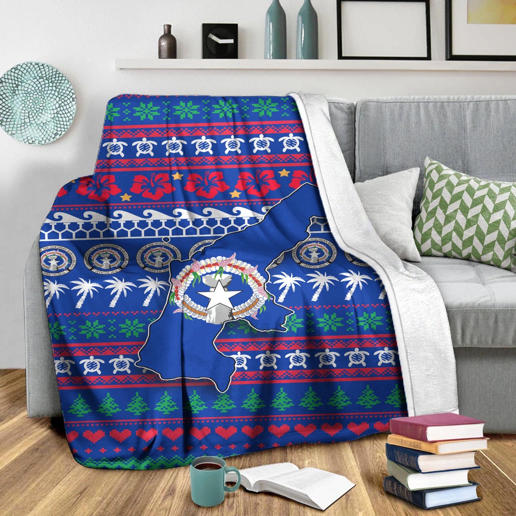 Blue North Mariana Islands Christmas blanket draped over couch with map, wreath and holiday stripes