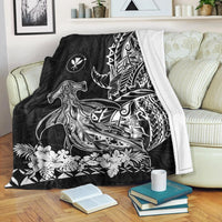 Black hammerhead shark blanket with tribal sail motif, draped over armrest