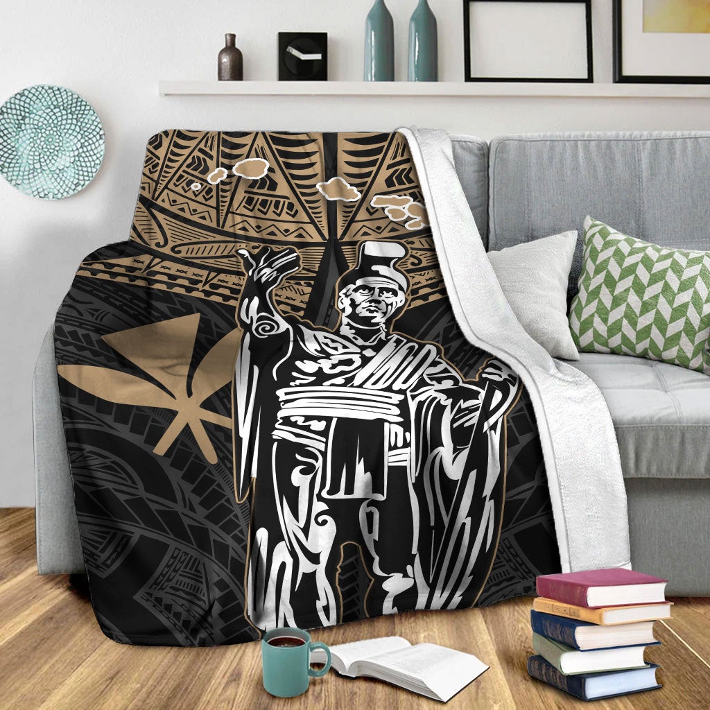 Black blanket with gold tribal border and large white king portrait, on bed