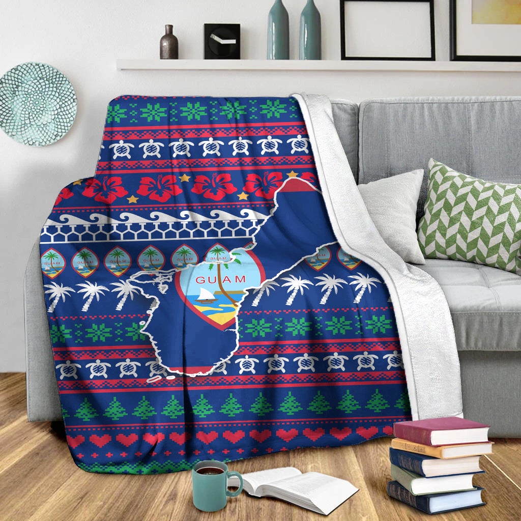Blue Guam Christmas blanket draped on couch with white sherpa-style backing edge