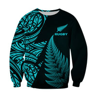 Unisex rugby sweatshirt, black with turquoise fern and “RUGBY” chest print