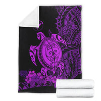 Folded Polynesian blanket with purple sea turtle, purple hibiscus and dark geometric print