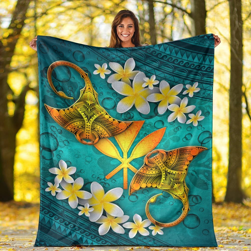 Turquoise Hawaii blanket showing manta ray, starfish symbol, and white-yellow plumeria blossoms