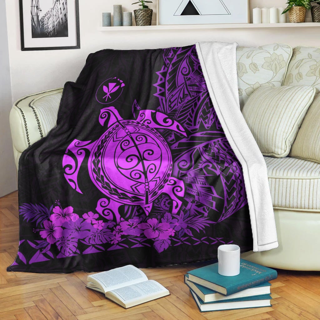 Purple sea turtle blanket draped over couch, geometric and floral design