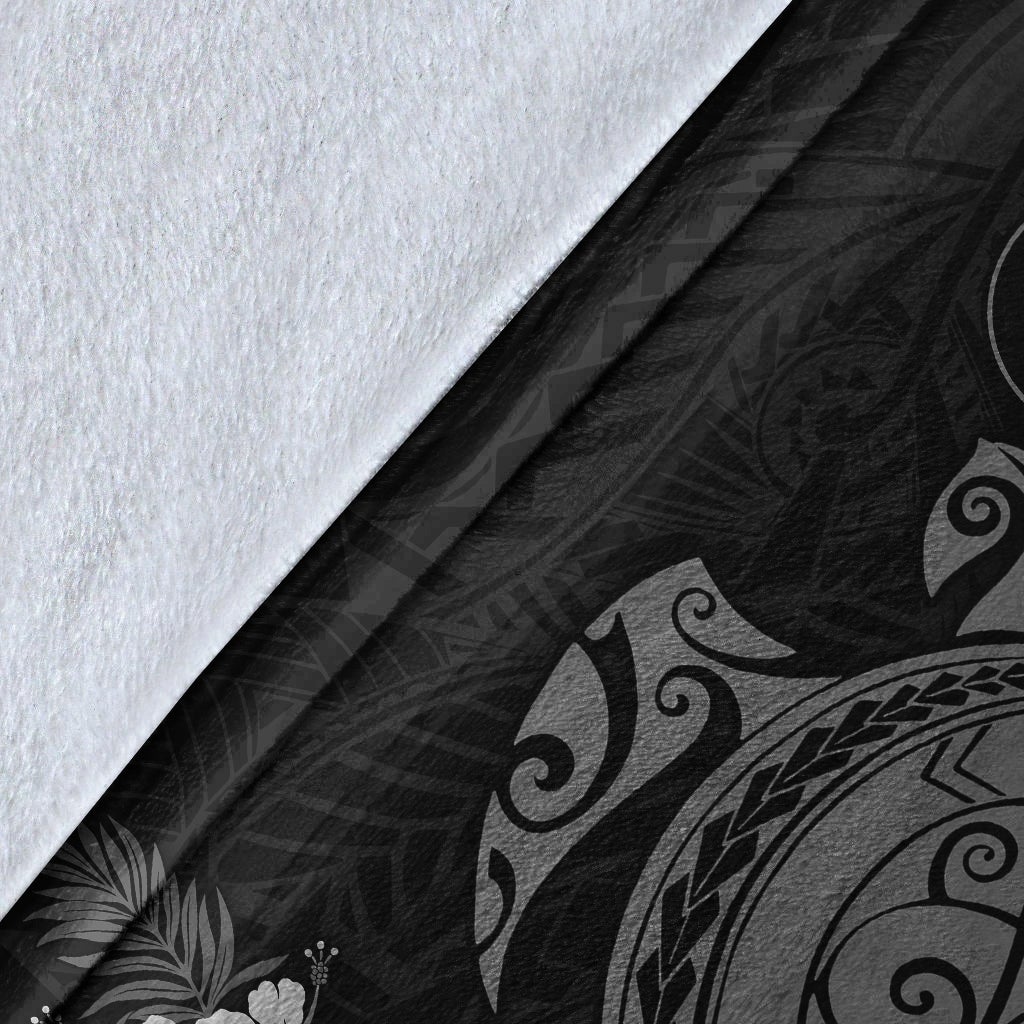 Close-up of gray sea turtle blanket fabric with tribal wave and swirl prints