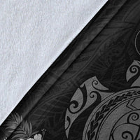 Close-up of gray sea turtle blanket fabric with tribal wave and swirl prints