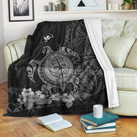 Gray sea turtle blanket draped over couch, white backing trim visible