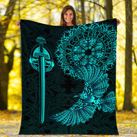 Black blanket held up, teal Viking raven tattoo emblem with sword and wing motif