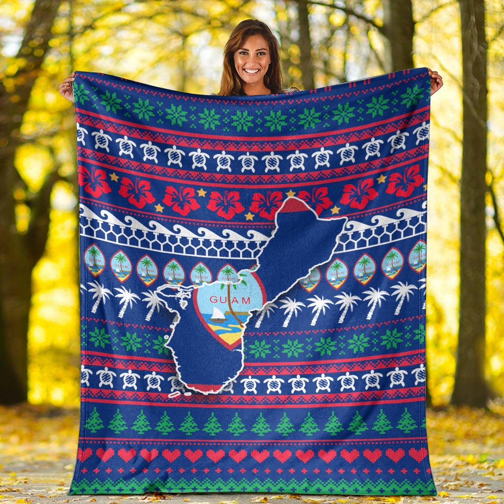 Blue Guam Christmas blanket with centered Guam outline, palm trees, and holiday stripes