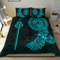 Black duvet cover set with teal raven wing and sword artwork on bed