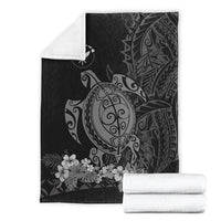 Folded gray sea turtle blanket with floral border and tribal swirl motif