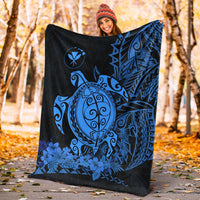 Blue sea turtle design Polynesian blanket laid outdoors on dark fabric with geometric side