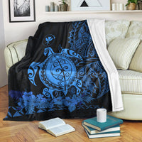 Polyneisan-style blue sea turtle blanket draped over sofa, floral leaf border pattern
