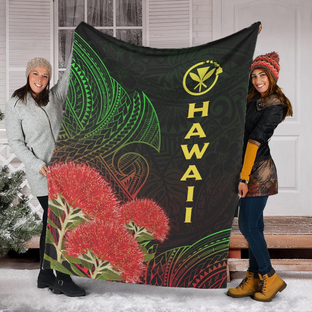 Black Hawaii Polynesian blanket held up, featuring green patterns, red ohia blossoms, yellow “HAWAII”