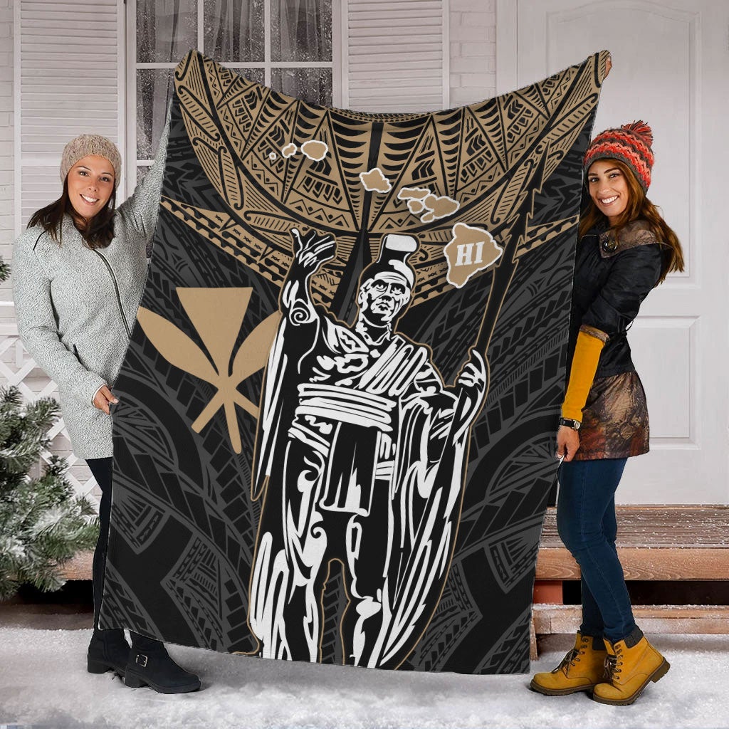 Black and gold Hawaii king blanket with white portrait, held up by two people