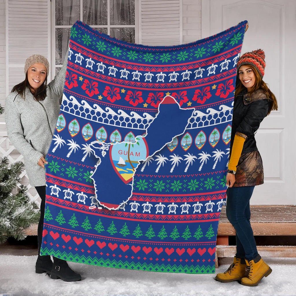 Blue Guam Christmas blanket spread on snow with holiday pattern and Guam map print