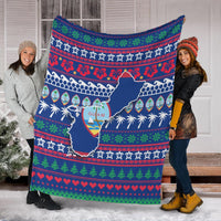 Blue Guam Christmas blanket spread on snow with holiday pattern and Guam map print