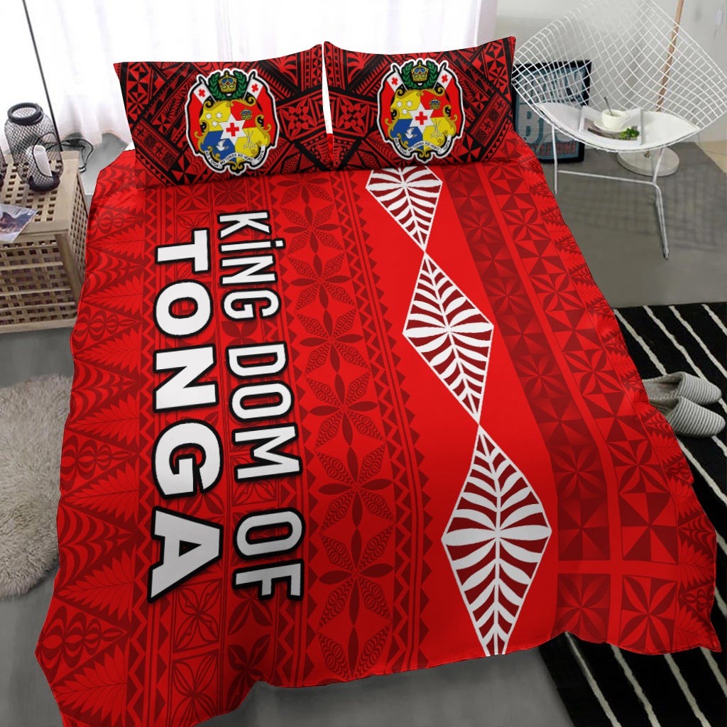 Red bedding cover with 'KINGDOM OF TONGA' lettering and white leaf designs, two crest pillows