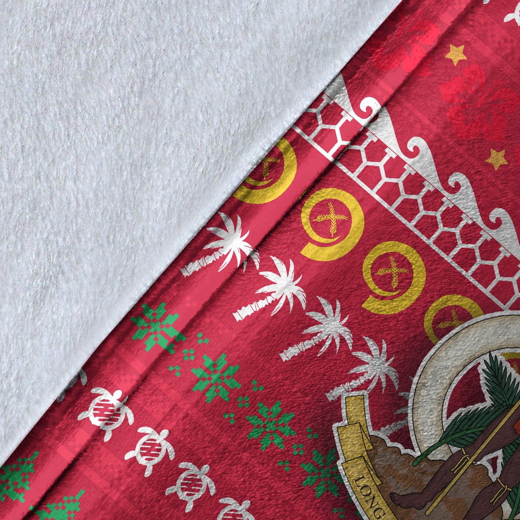 Close-up red blanket fabric with white and yellow geometric band, palms, and green accents