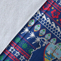 Close-up of blue Guam Christmas blanket fabric: palm trees, hearts, and Guam map print