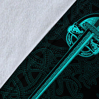 Close-up of black blanket fabric with teal diagonal rune sword and chain detailing