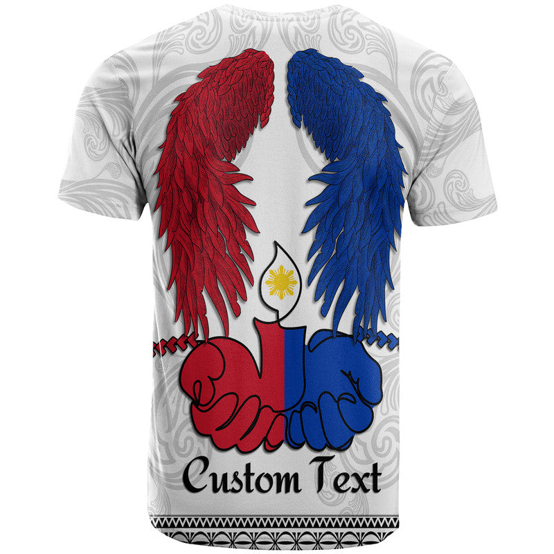 White crewneck T-shirt, back graphic with red and blue wings, praying hands, “Custom Text”