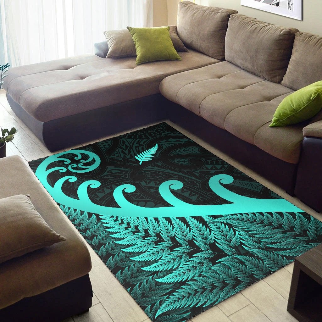 Turquoise fern and koru motif on dark green area rug with leaf border trim