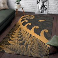 Rectangular area rug featuring gold koru swirls over fern-style leaf pattern