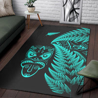 Black area rug with turquoise fern branches and Maori mask artwork