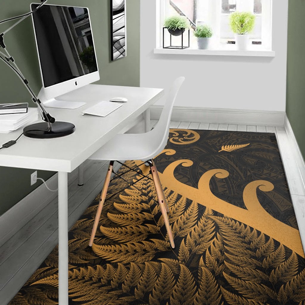Gold fern frond and koru emblem area rug with dark tribal pattern, rectangular
