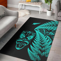 Turquoise fern and Maori mask design area rug on dark background