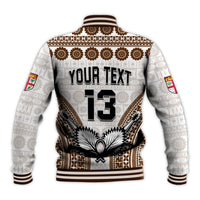 White baseball jacket with tapa-style border, “YOUR TEXT” and “13” on back