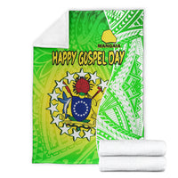 Green and white Happy Gospel Day blanket with crest, shown with rolled white towels