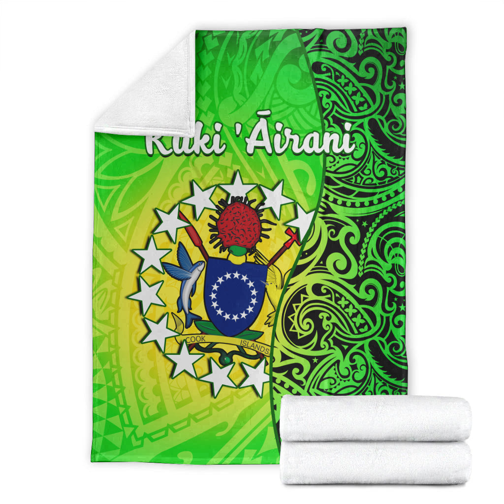 Folded green Cook Islands turtle blanket with crest artwork and ornamental swirls