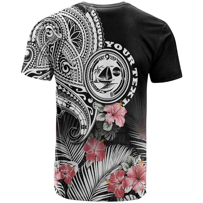 Black graphic T-shirt with large tribal crest, hibiscus flowers, and partial text