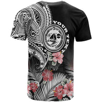 Black graphic T-shirt with large tribal crest, hibiscus flowers, and partial text