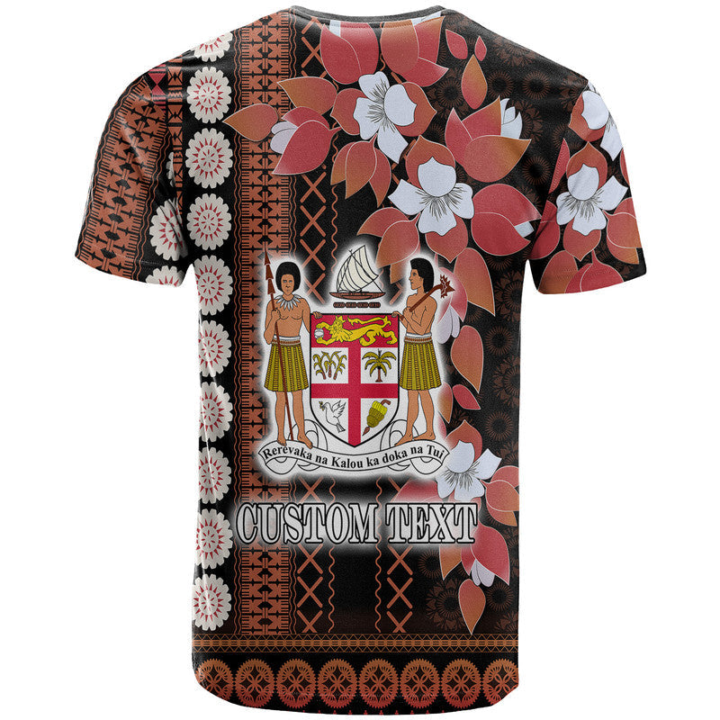 Black tapa-style T-shirt with floral print and crest scene; CUSTOM TEXT graphic