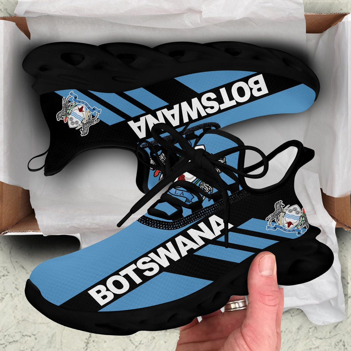 Black-sole clunky sneakers with Botswana stripe graphic and black laces