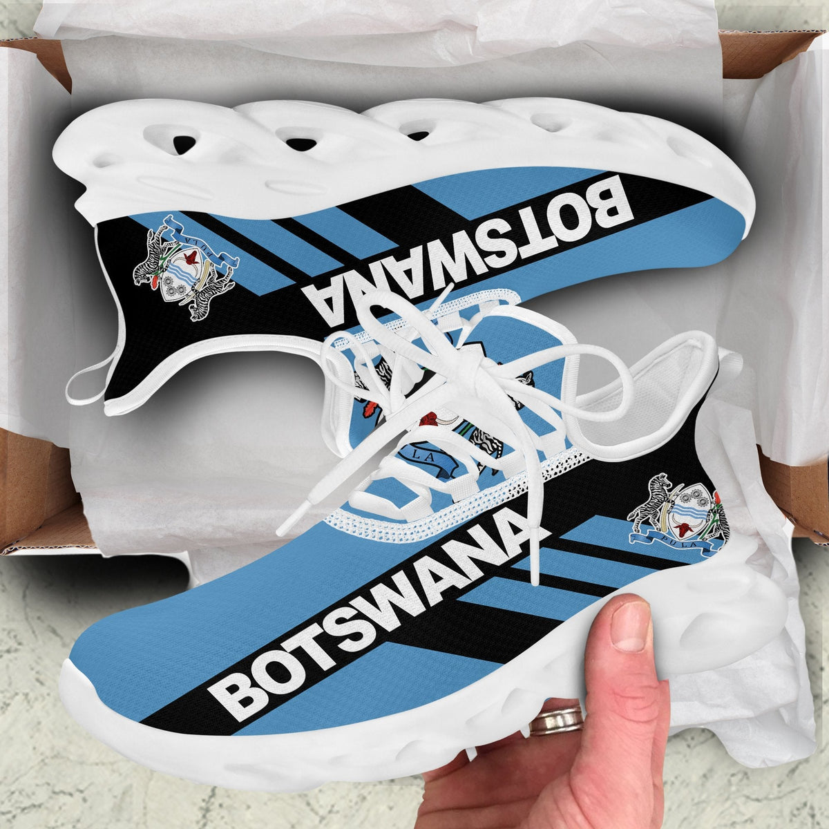 White-sole clunky sneakers with Botswana stripe graphic and black-to-blue laces