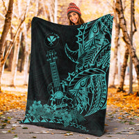 Turquoise on black Hawaiian blanket with ukulele and floral tiki patterns, draped