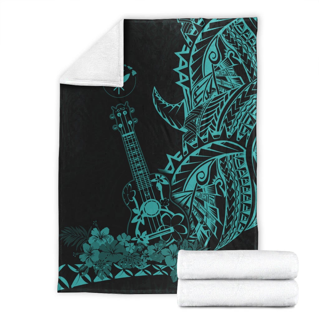 Folded black Hawaiian blanket with turquoise ukulele and floral tiki design