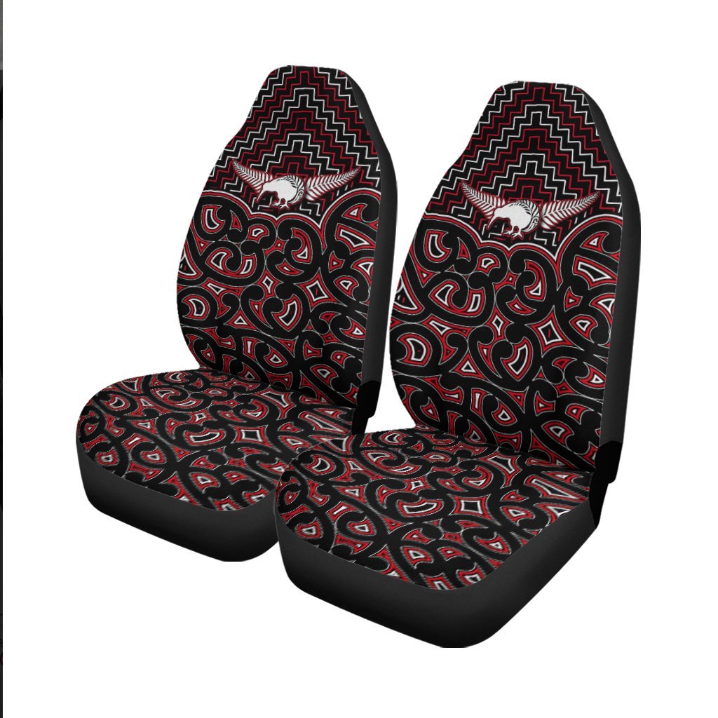 Front car seat covers showing red-and-white Maori motifs on black fabric, two seats.