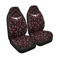 Front car seat covers with black base and red/white Maori graphic pattern, paired.