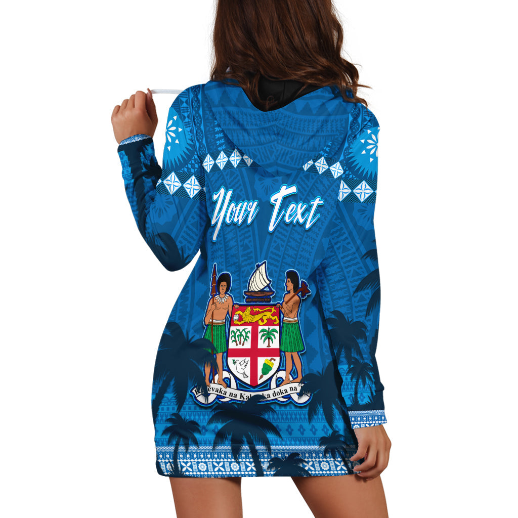 Blue hoodie dress back view with palm silhouettes, tapa pattern, large crest graphic