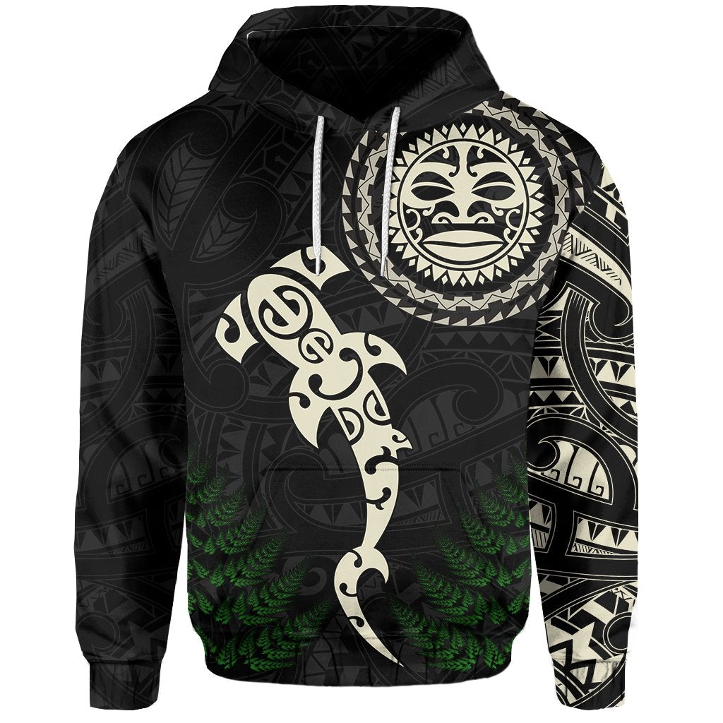 Black hoodie front with large round face emblem, fern details, and Maori patterns