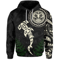 Black hoodie front with large round face emblem, fern details, and Maori patterns