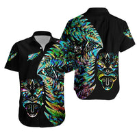 Black short-sleeve Hawaiian shirt with colorful tiki mask and feather artwork, button-up