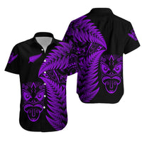 Black short-sleeve button shirt with purple fern and tribal face graphic on chest and back
