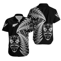 Black button-up Hawaiian shirt with silver fern and tiki face print, front and back views