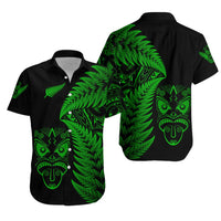 Black short-sleeve button-up shirt with green fern and tribal face prints on front and back